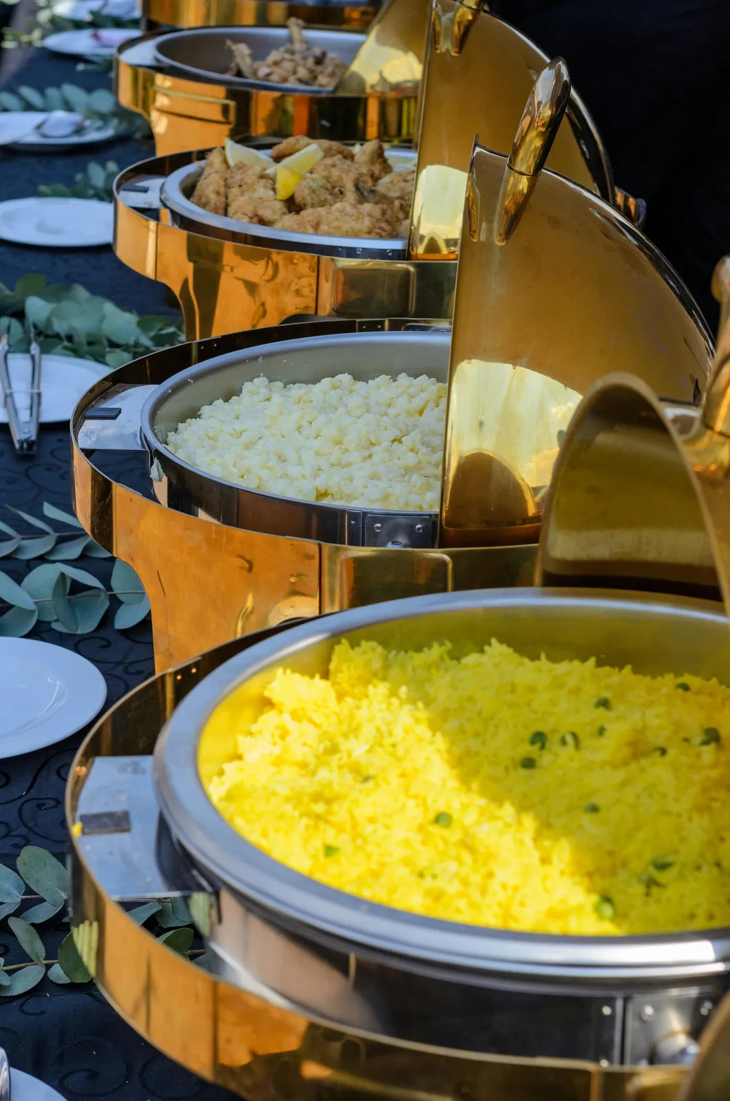Standard wedding buffet with rice and curries in chafing dishes